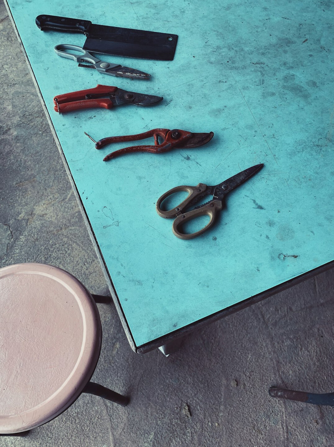 Overhead view of a workshop table with notebooks, laptop and coffee cups