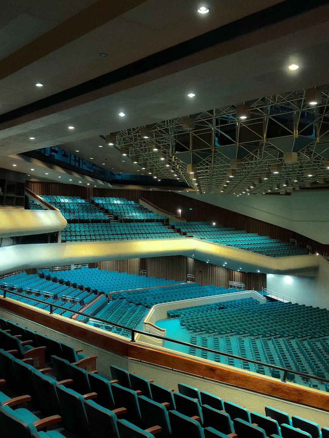 Empty auditorium stage with spotlights and rows of seats